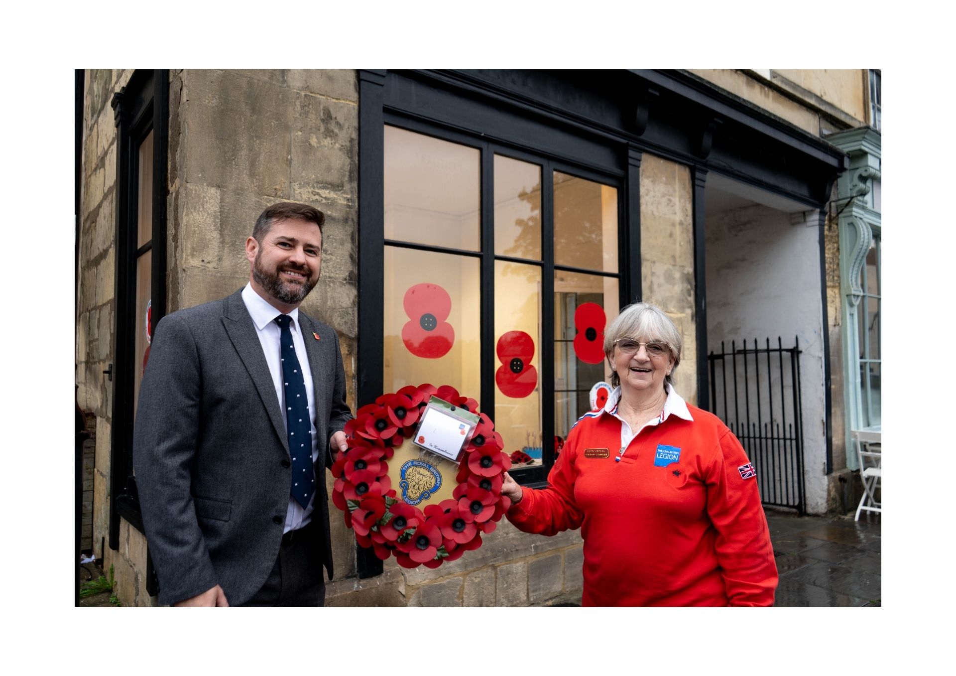 Councillor and Poppy Appeal coordinator outside the shop at 27 Walcot Street