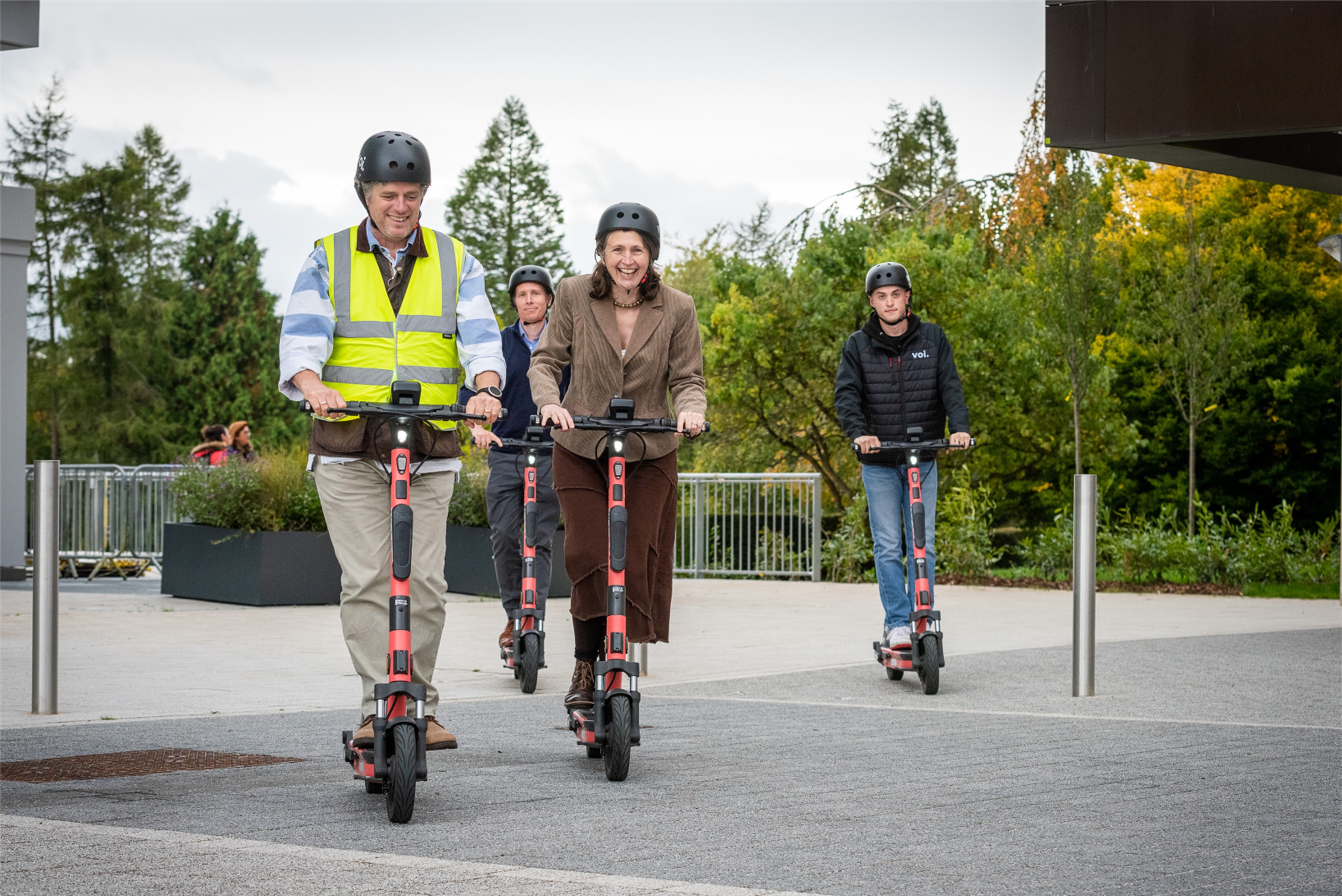 Councillor Matt McCabe, Ian Blenkharn, Councillor Sarah Warren and Alfie Marsh riding the e-scooters at the University of Bath’s Claverton Down campus