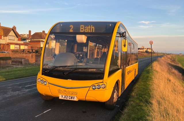 An exterior photo of The Big Lemon bus with Bath displayed on the front