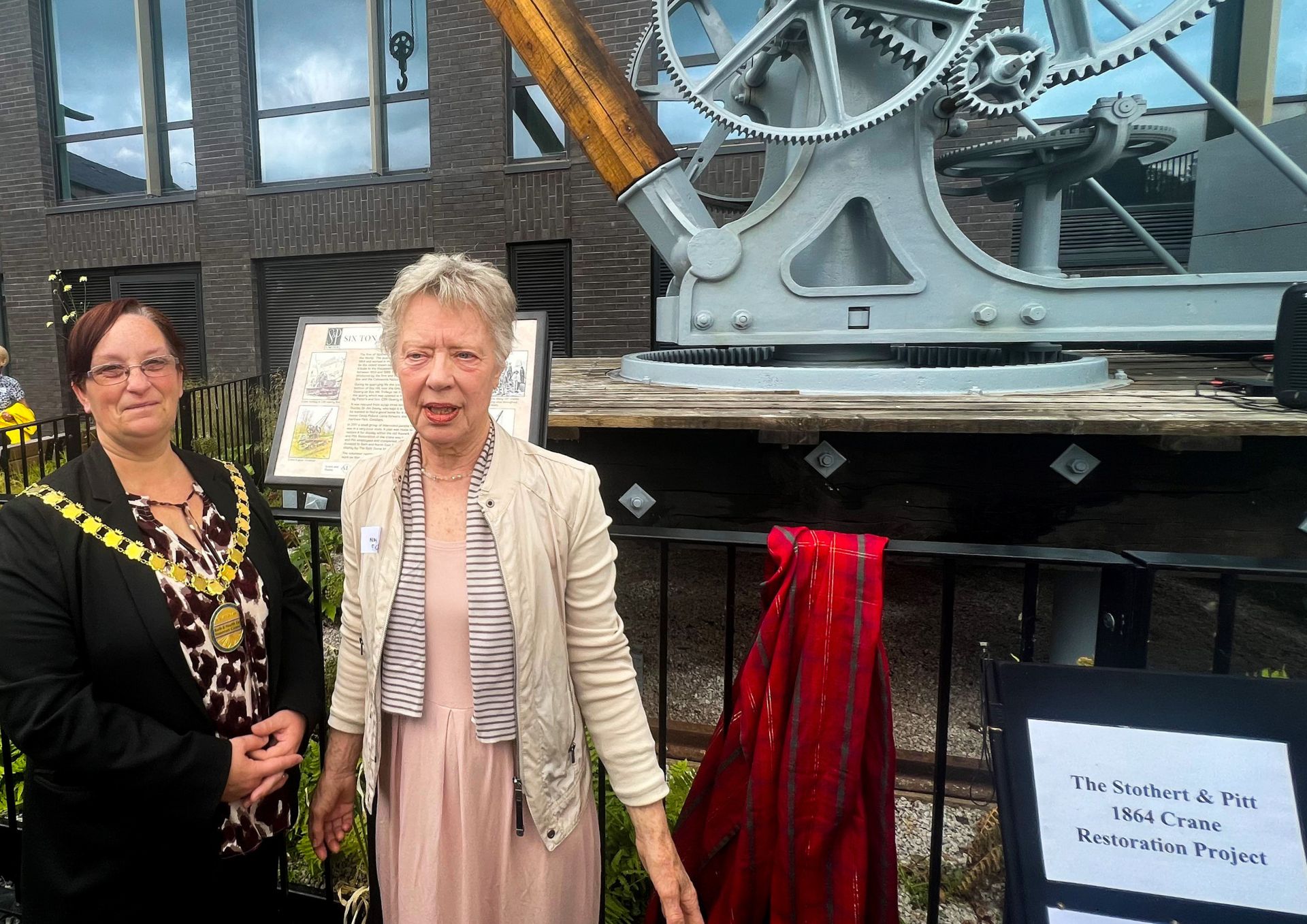 Councillor Sarah Moore, chair of Bath & North East Somerset Council and Nina Pollard in front of the crane