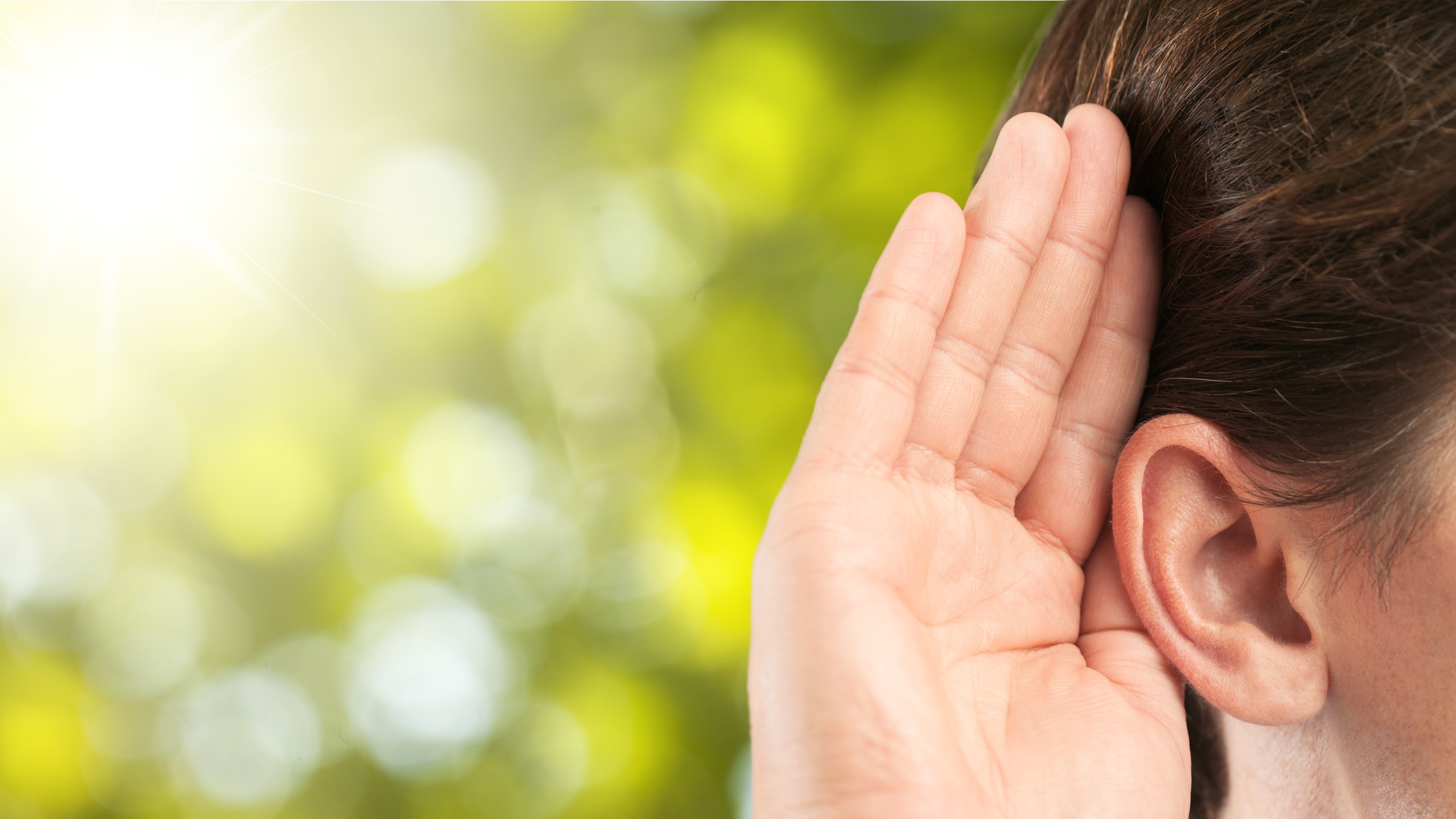 Hand cupped over ear to showcase someone is listening