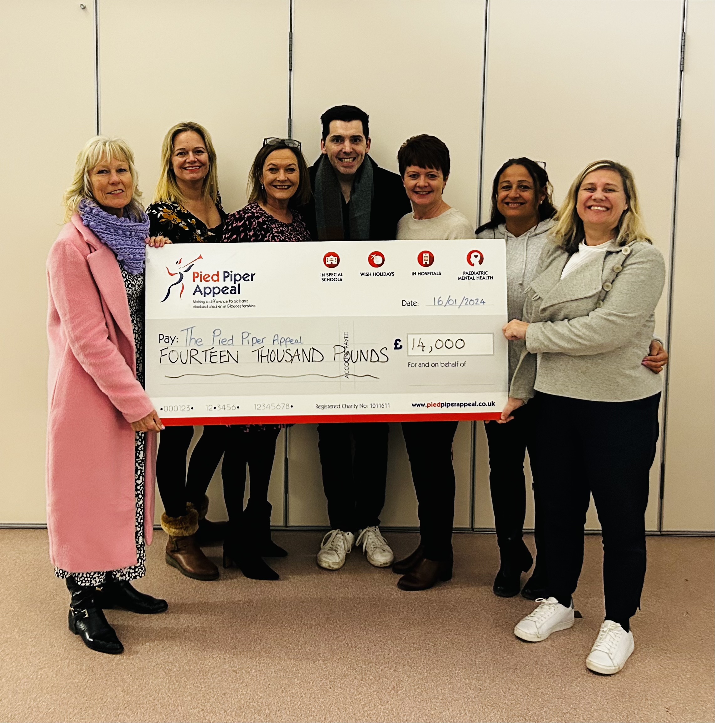 STaff from Pied Piper Appeal with giant cheque