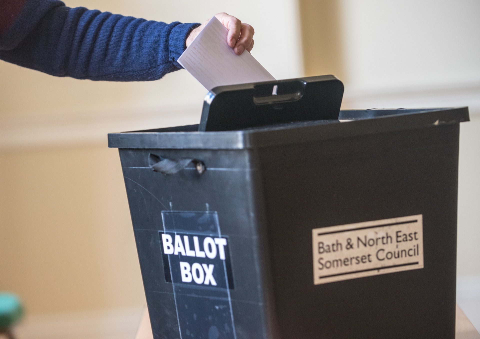 Photo of someone dropping a vote into a black B&NES ballot box