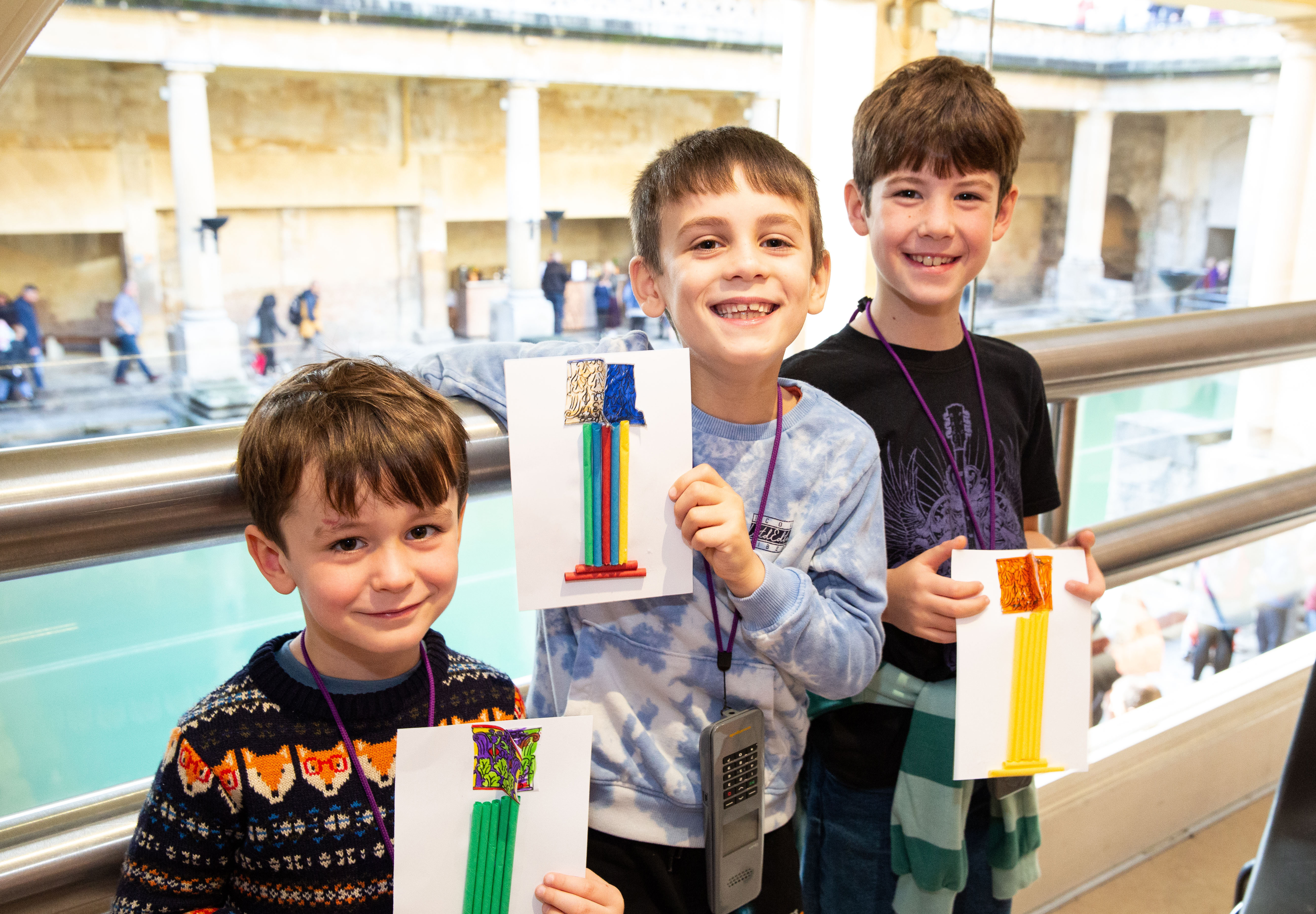 Three boys at the Roman Baths, holding their crafts