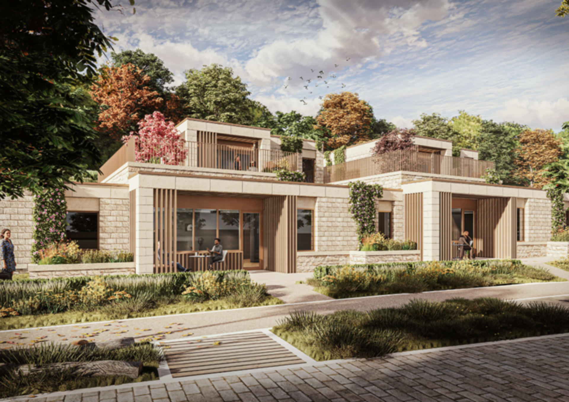 architect's visualisation of two-storey stone buildings with a ground floor veranda with a person sat at a table. People walking in front of the buildings with green planting alongside the path and trees in the background. 