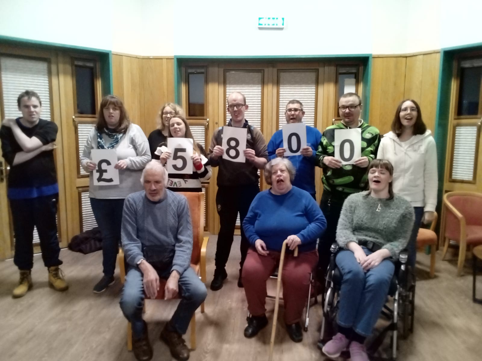 group photo holding up numbers to form £5800