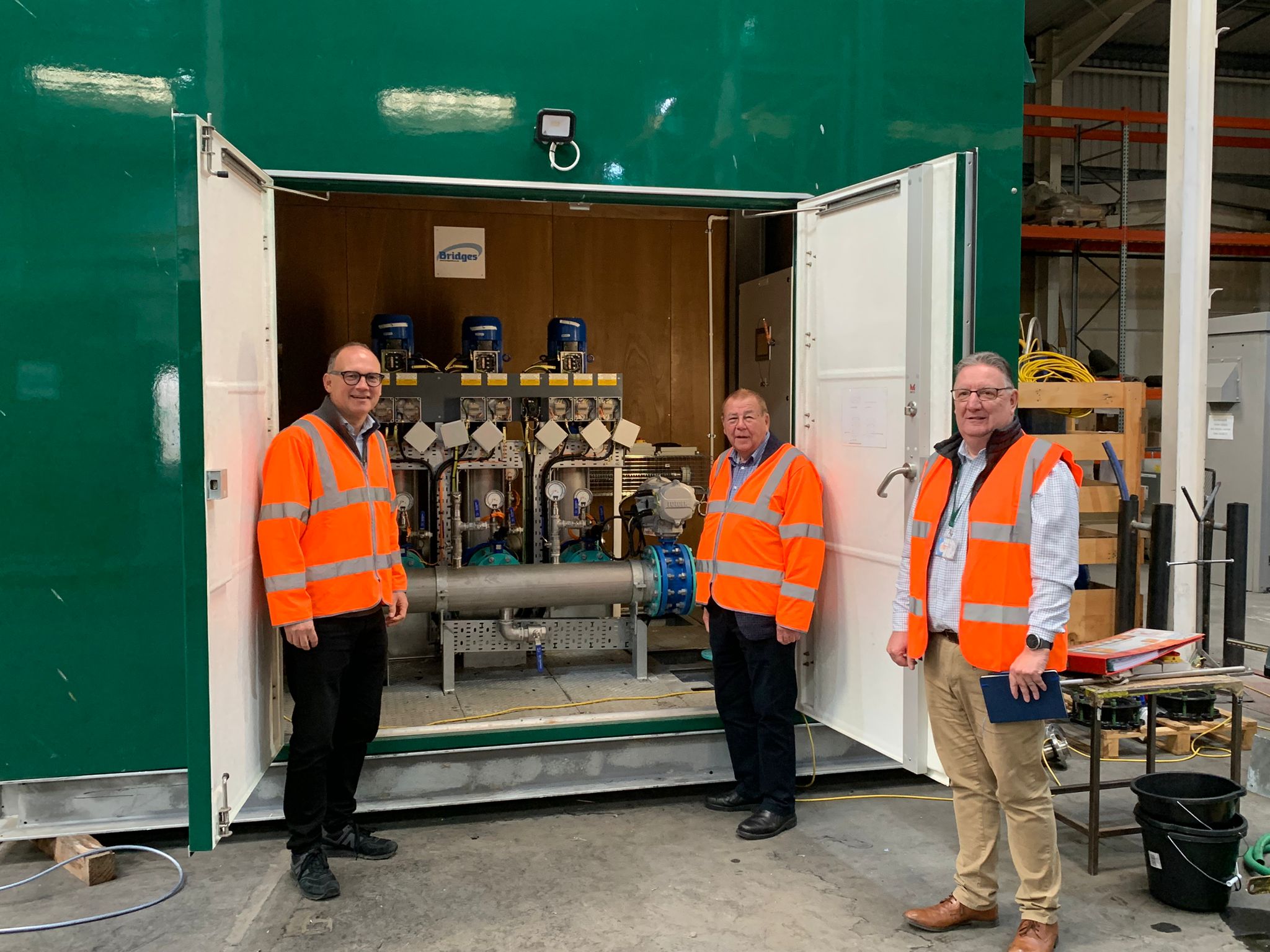 image shows Councillor Paul Roper, Councillor Paul May and a representative from Bridges looking at electrical engineering equipment 