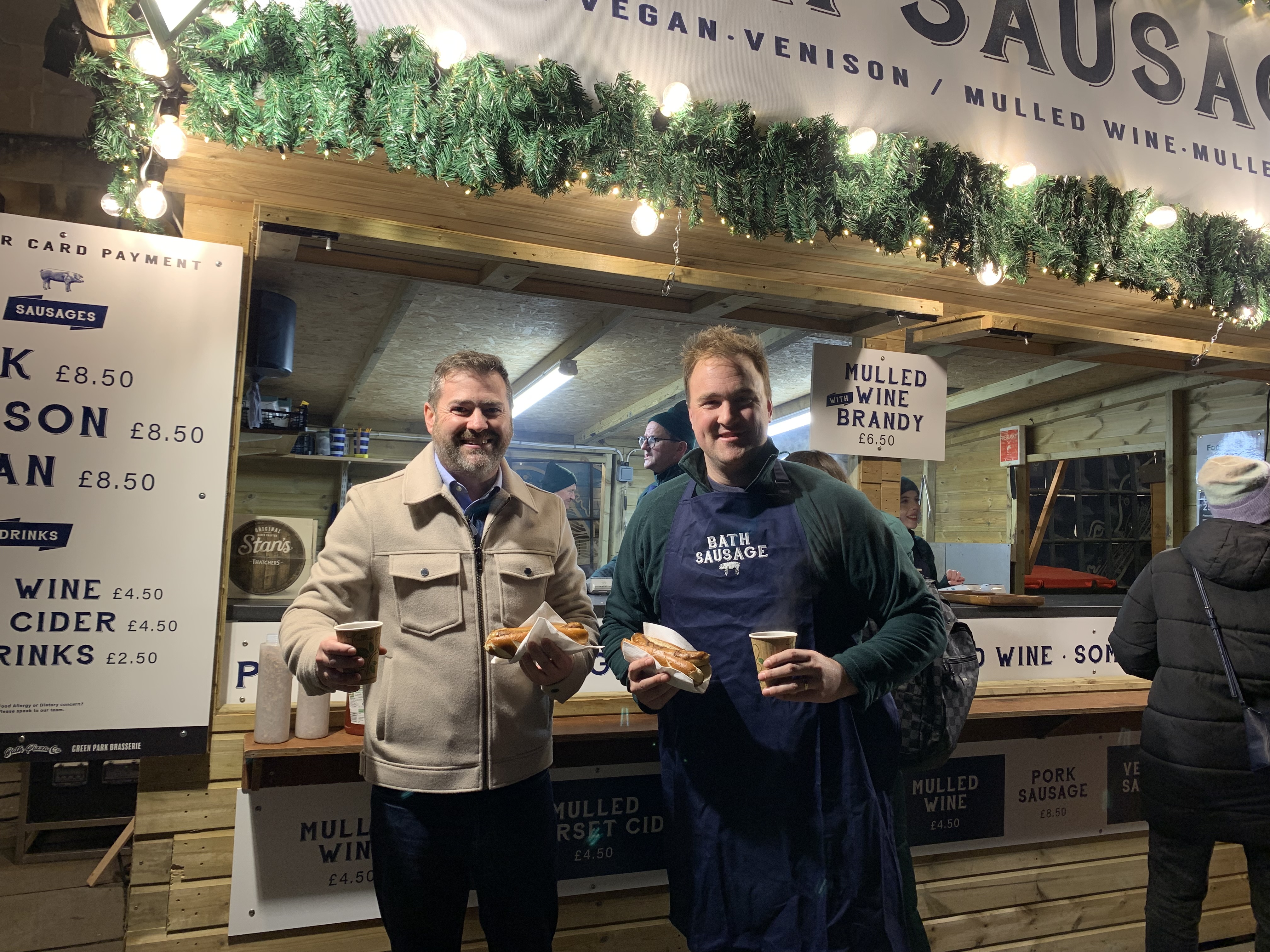 Cllr Kevin Guy, Leader of Bath & North East Somerset Council and Alex Peters, who runs the Bath Sausage Company (pictured) at Bath Christmas Market.