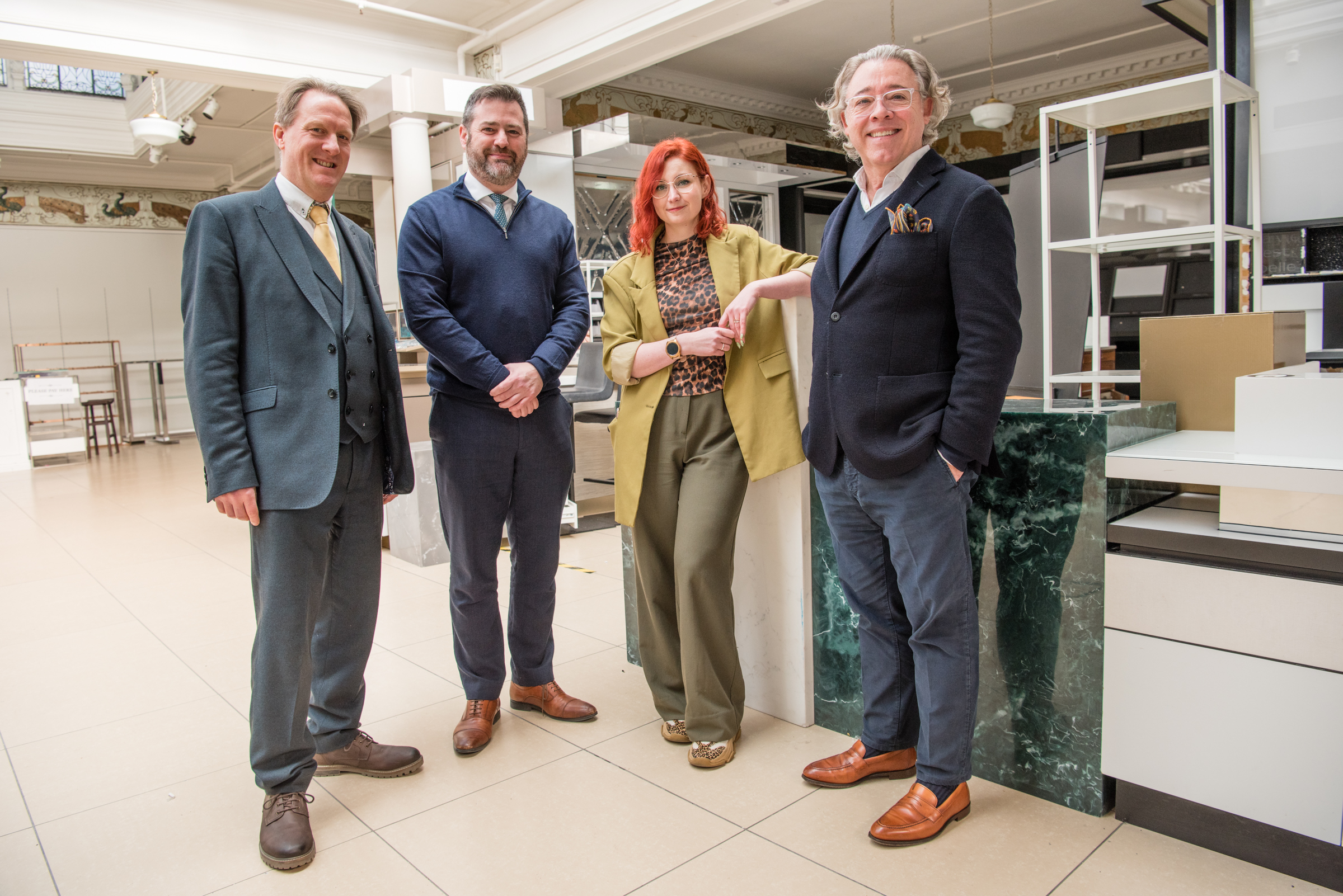 Four people stand in Jolly's department store