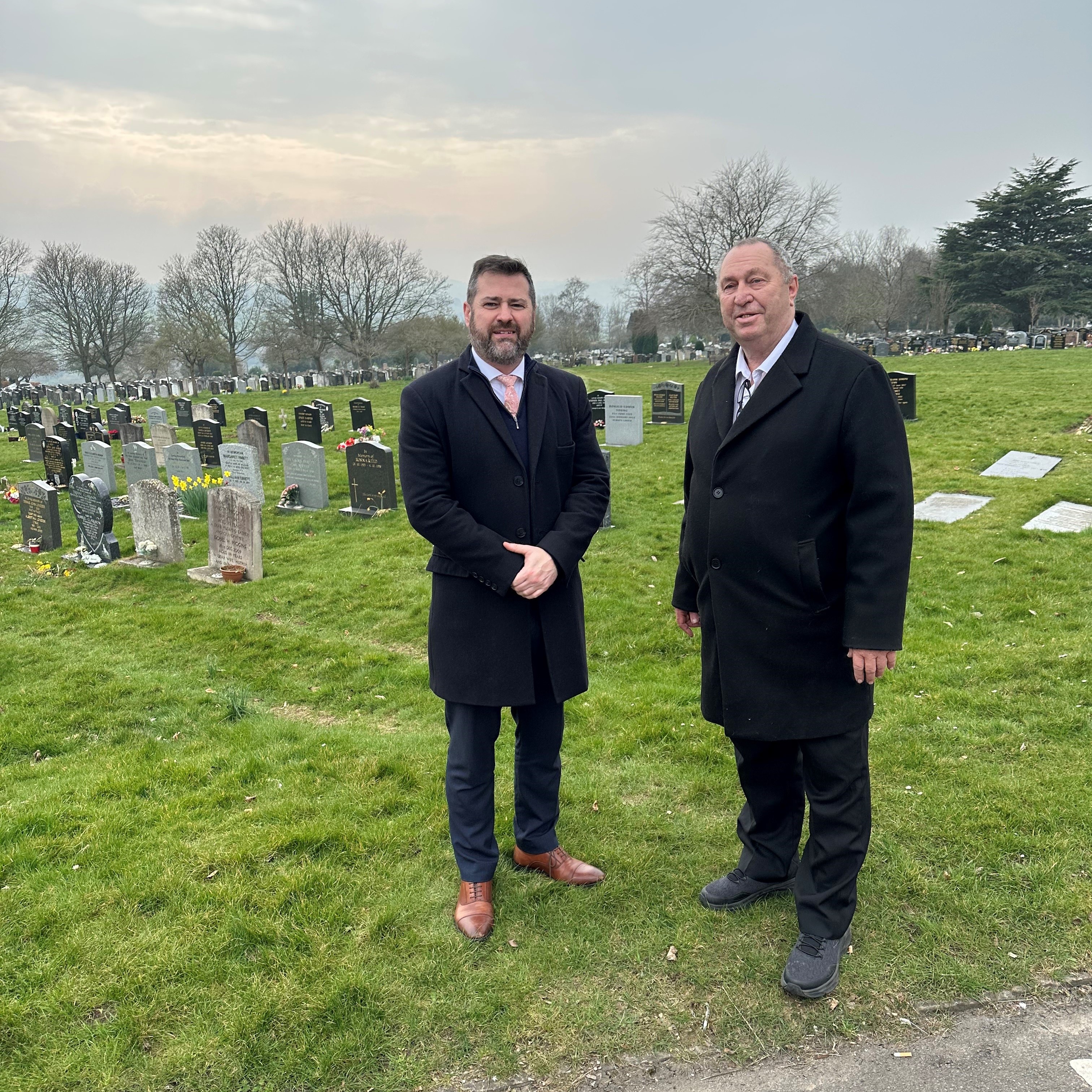 Two people stand outside at Haycombe Cemetery