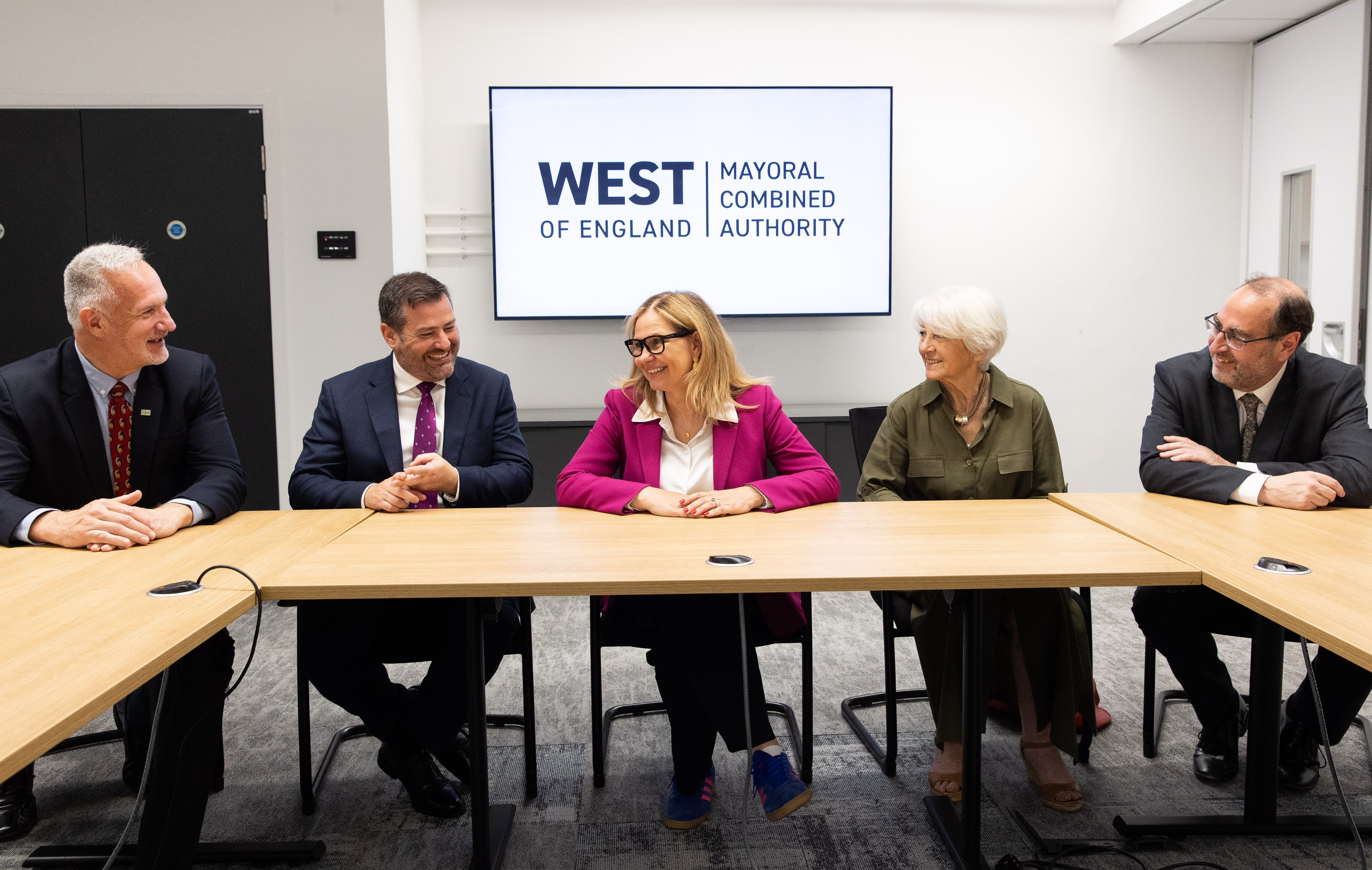 Council leaders sit a desk with Helen Godwin in the centre, smiling