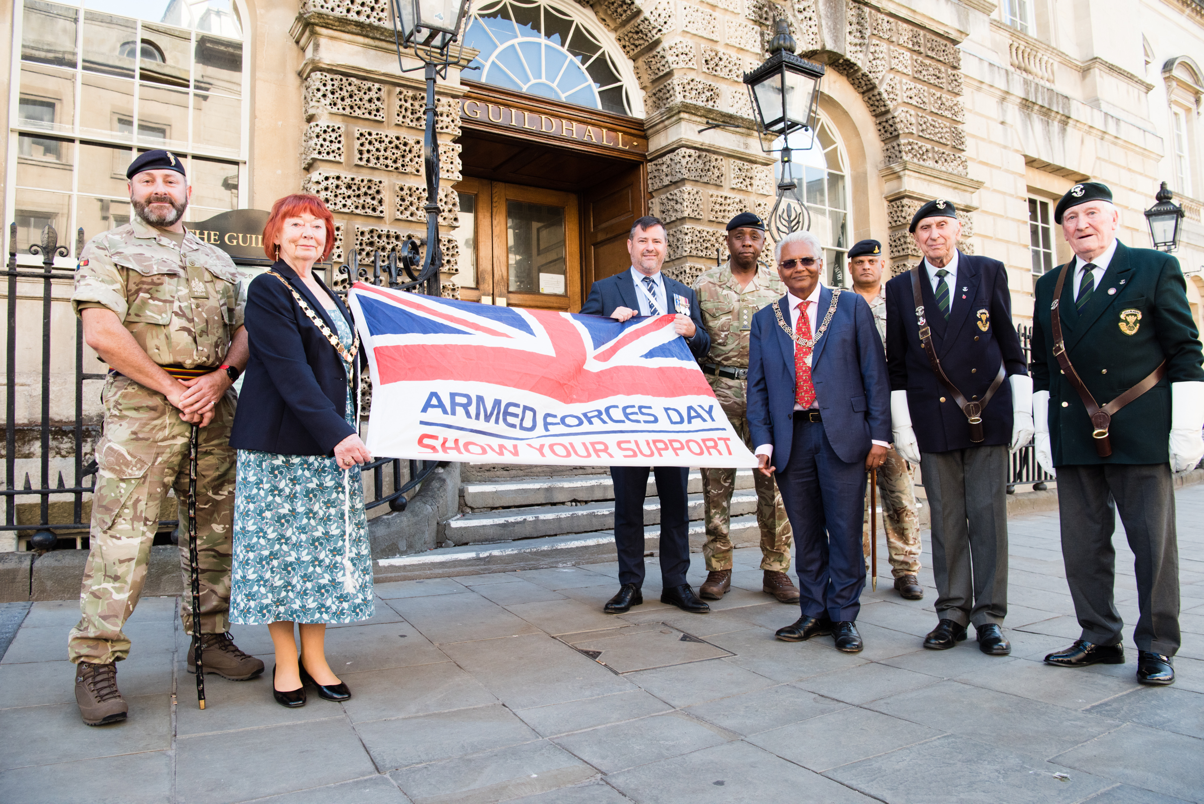Displaying the Armed Forces flag outside The Guildhall, Bath. From left to right: Laurence Nelson ROSO 101 Battalion REME, Chair Councillor Liz Hardman, Council leader Councillor Kevin Guy, Captain John Ledgister, Bath Mayor Councillor Bharat Pankhania, Fawzi Peeroo Regimental Operational Support Officer (ROSO)  243 Multi-Role Medical Regiment (MMR), standard bearers John Watson  Somerset Light Infantry and Cyril Soan Territorial Army Somerset Light Infantry.