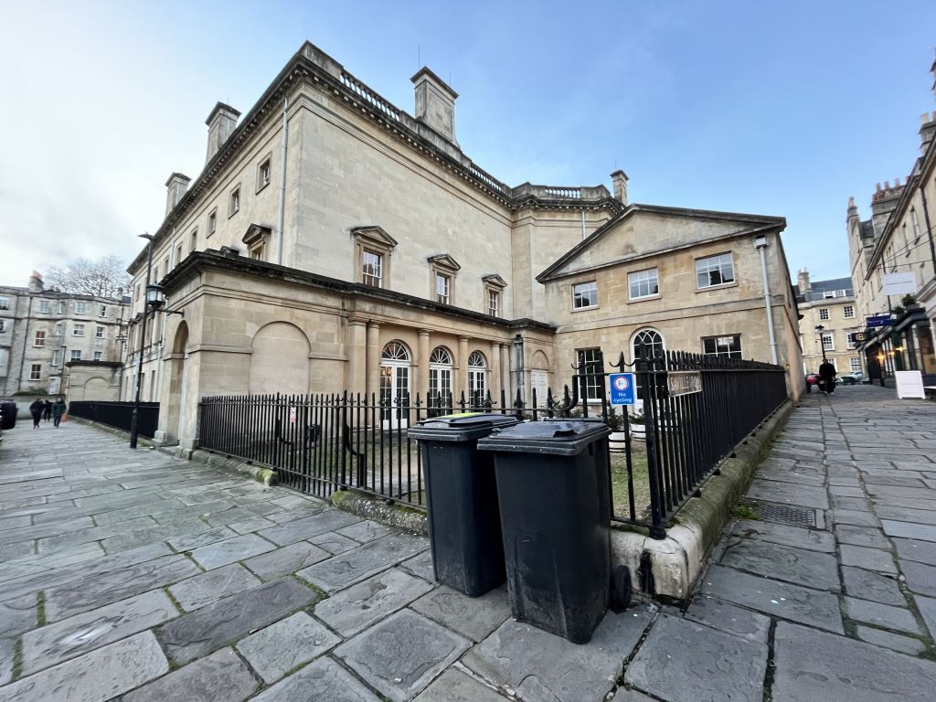 Bath city centre street with black wheeled bins