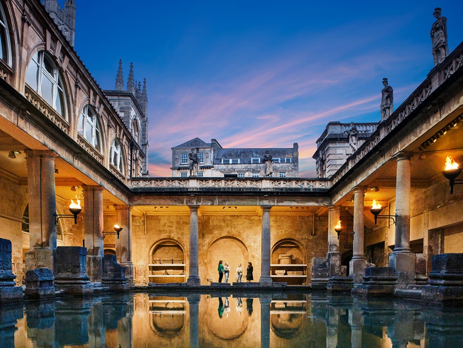 The Roman Baths illuminated by torchlight