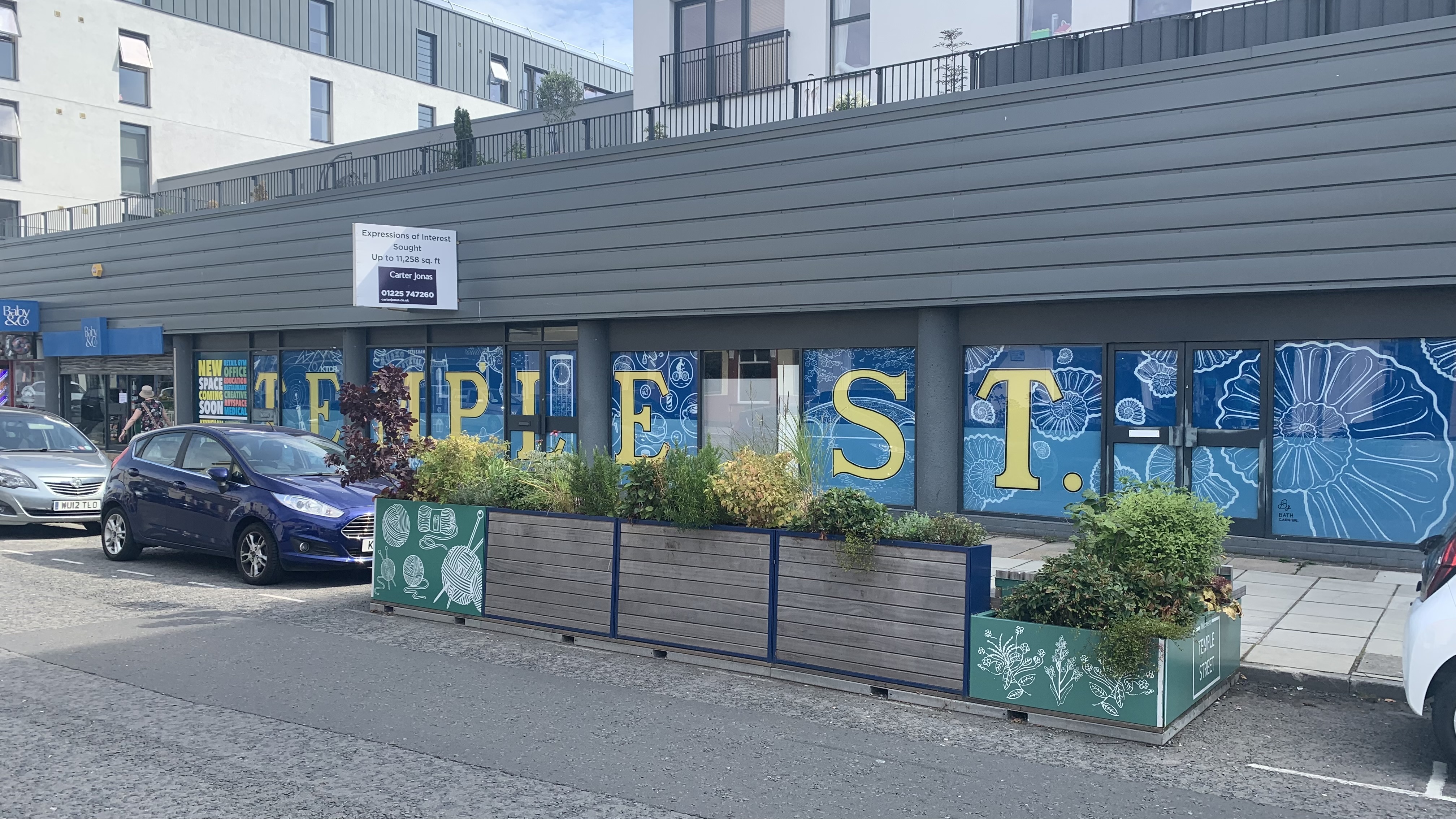 Vacant units in Keynsham with planters in front