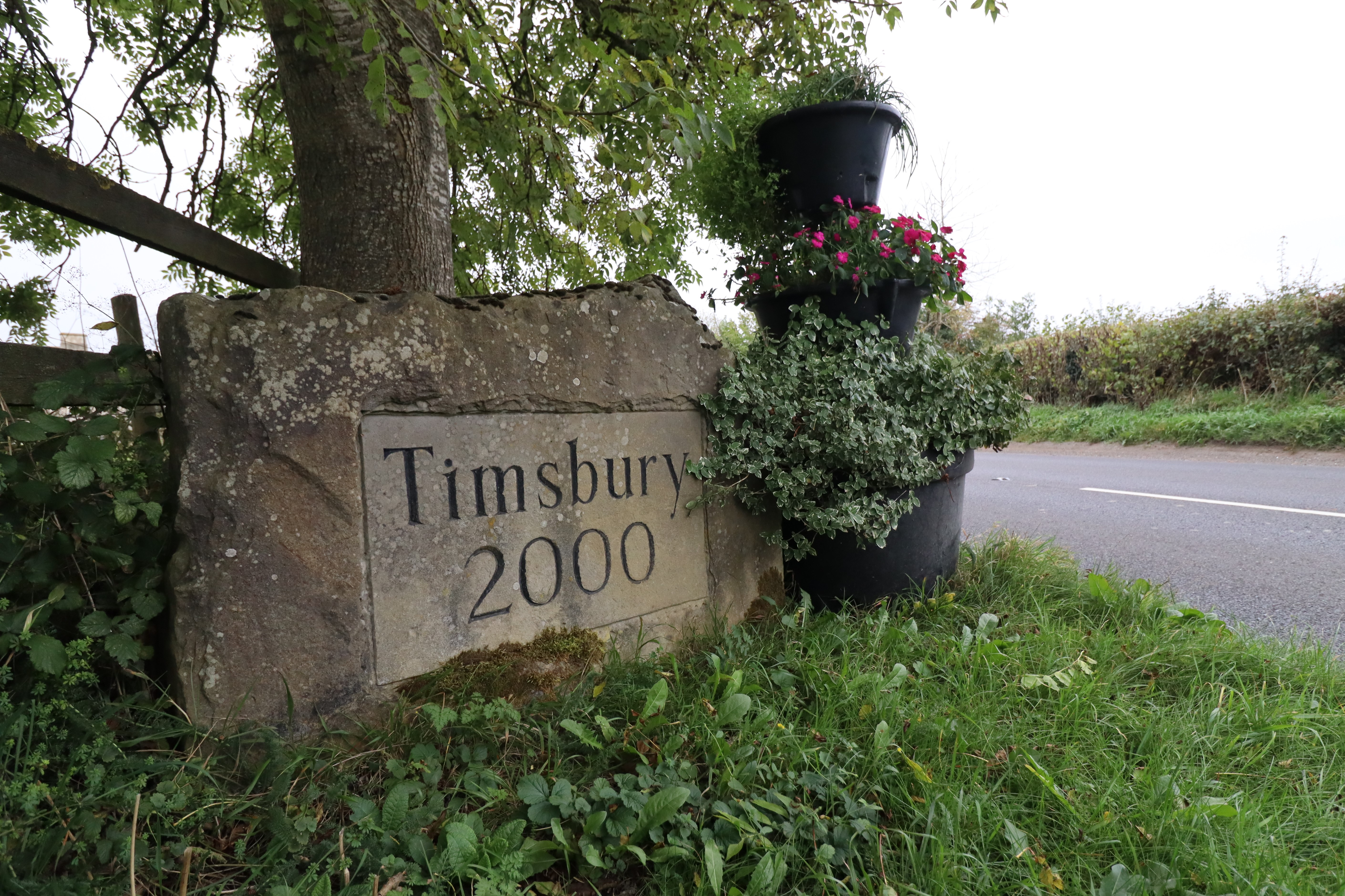 A large stone marking the boundary of Timsbury Village, engraved into the stone is 'Timsbury 2000'. 