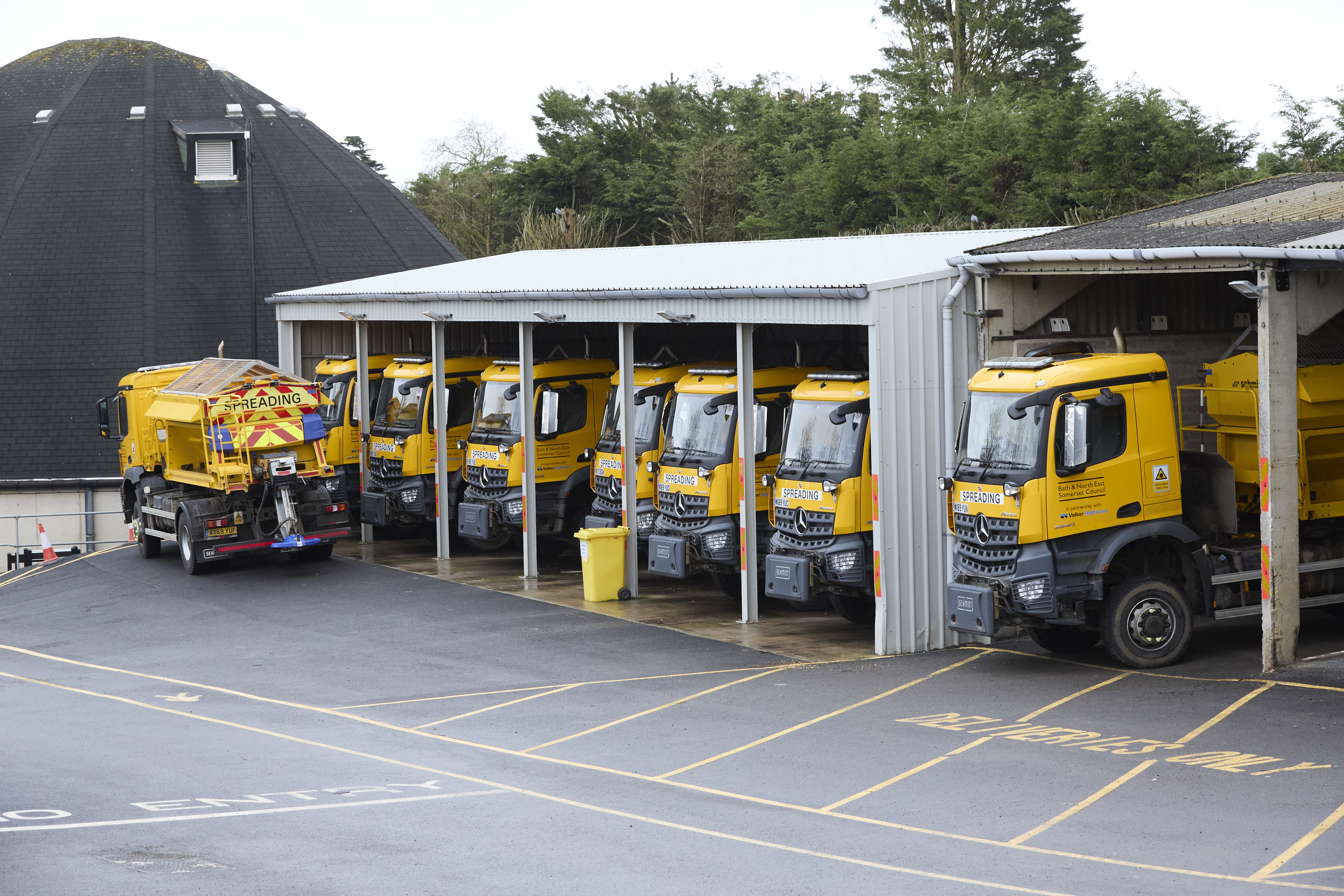 Gritting lorries parked under cover. 