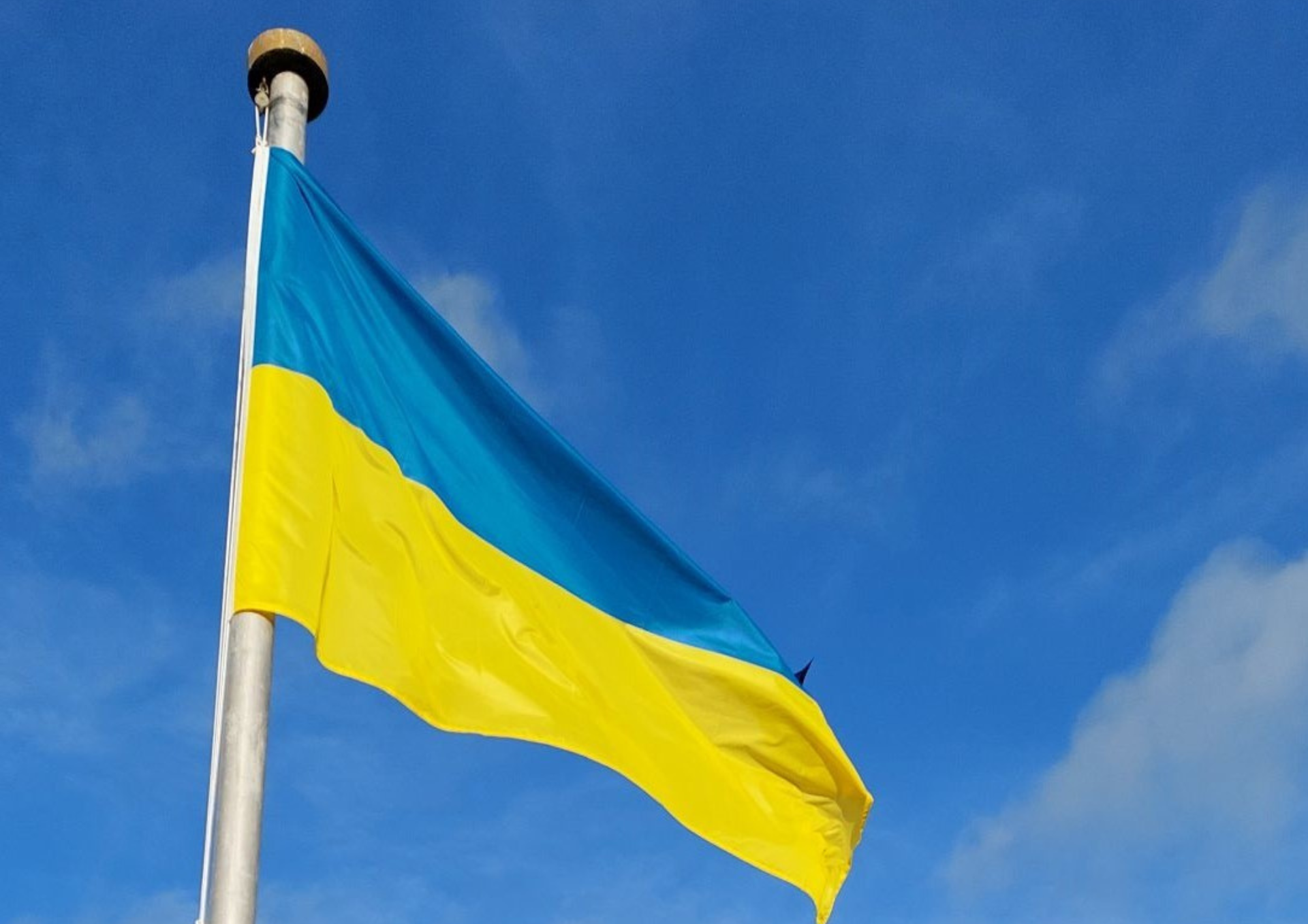 photo of a ukrainian flag against a blue sky
