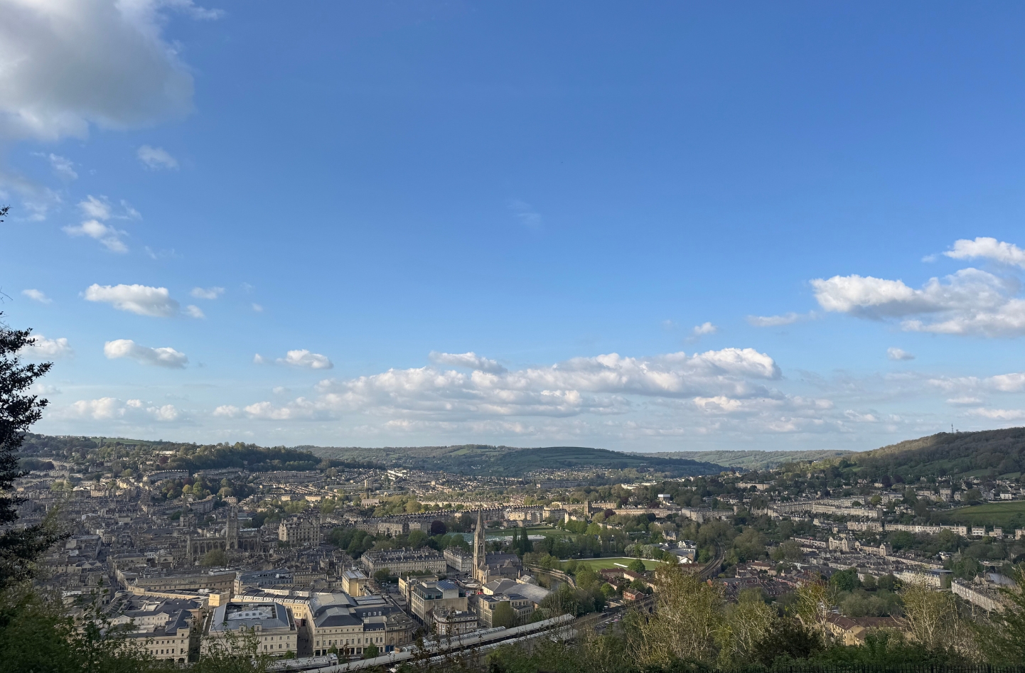 A scenic hilltop viewpoint of Bath city centre with blue skies