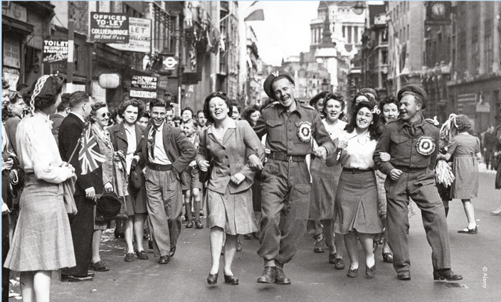 Black and white photo of people celebrating VE day.
