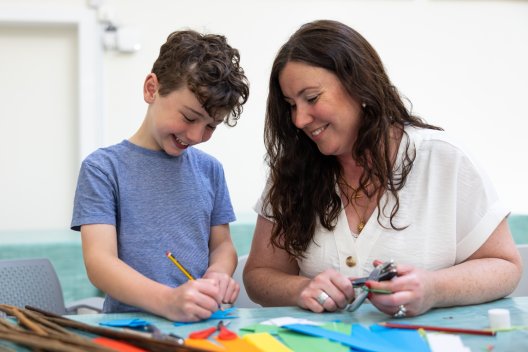 A woman and child doing draft activities at Victoria Art Gallery