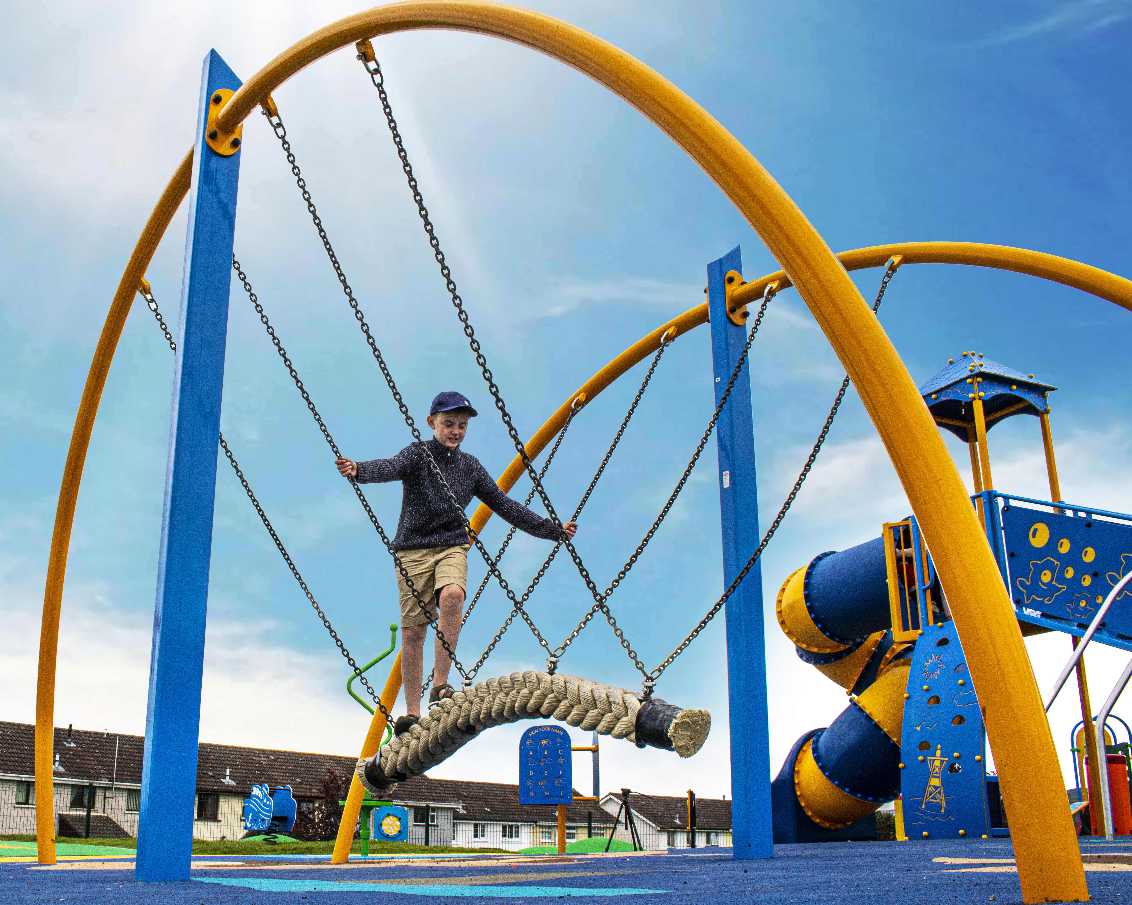 Child climbs on a rope play structure