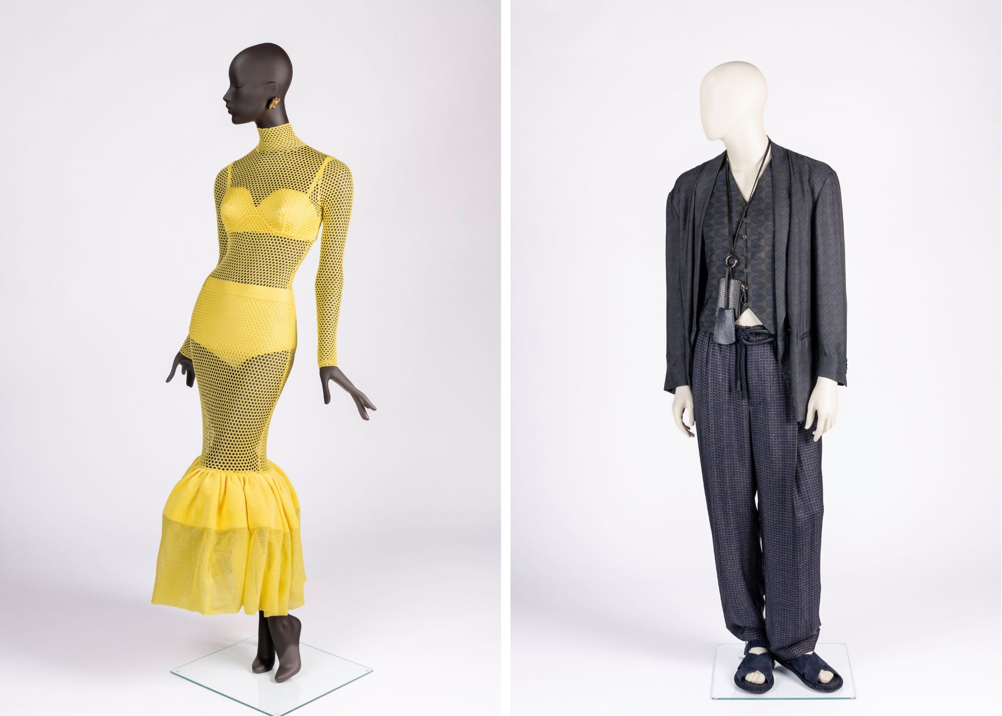 (Left) BATMC 2026.13 Dress of the Year 2025 Acid yellow knitted mesh stitch dress worn over bra and high-waisted briefs and accessorised with black leather square toe boots and sculptural crystal earrings by Sarah Burton for Givenchy, Autumn/Winter 2025  (Right) BATMC 2026.14 Dress of the Year 2025 Navy blue viscose jacket, trousers and waistcoat accessorised with rope belt, leather lanyard with keyring and coin purse, and suede leather sandals by Giorgio Armani, Spring/Summer 2026