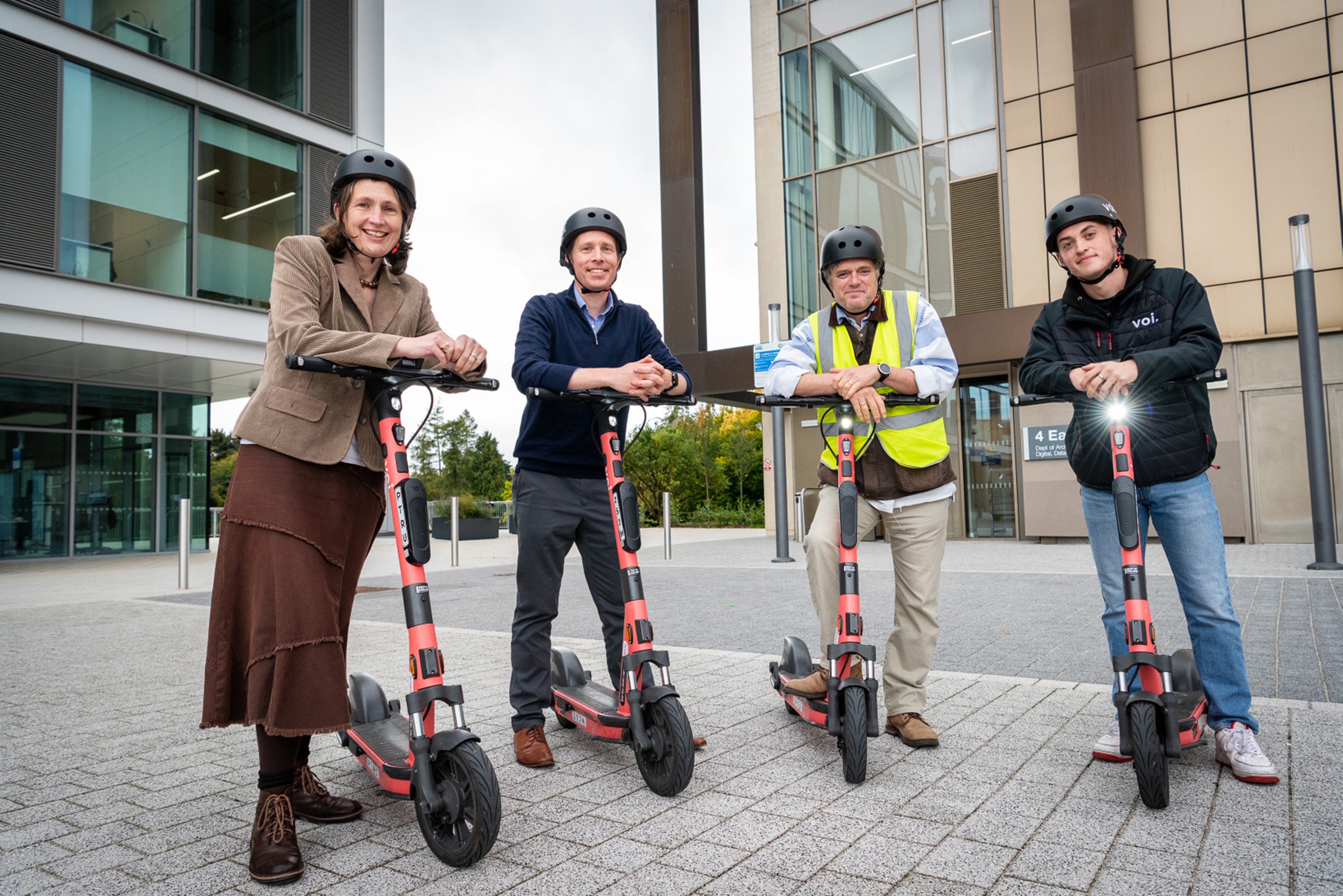 Councillor Sarah Warren, Ian Blenkharn, Councillor Matt McCabe and Alfie Marsh standing with e-scooters at the University of Bath’s Claverton Down campus