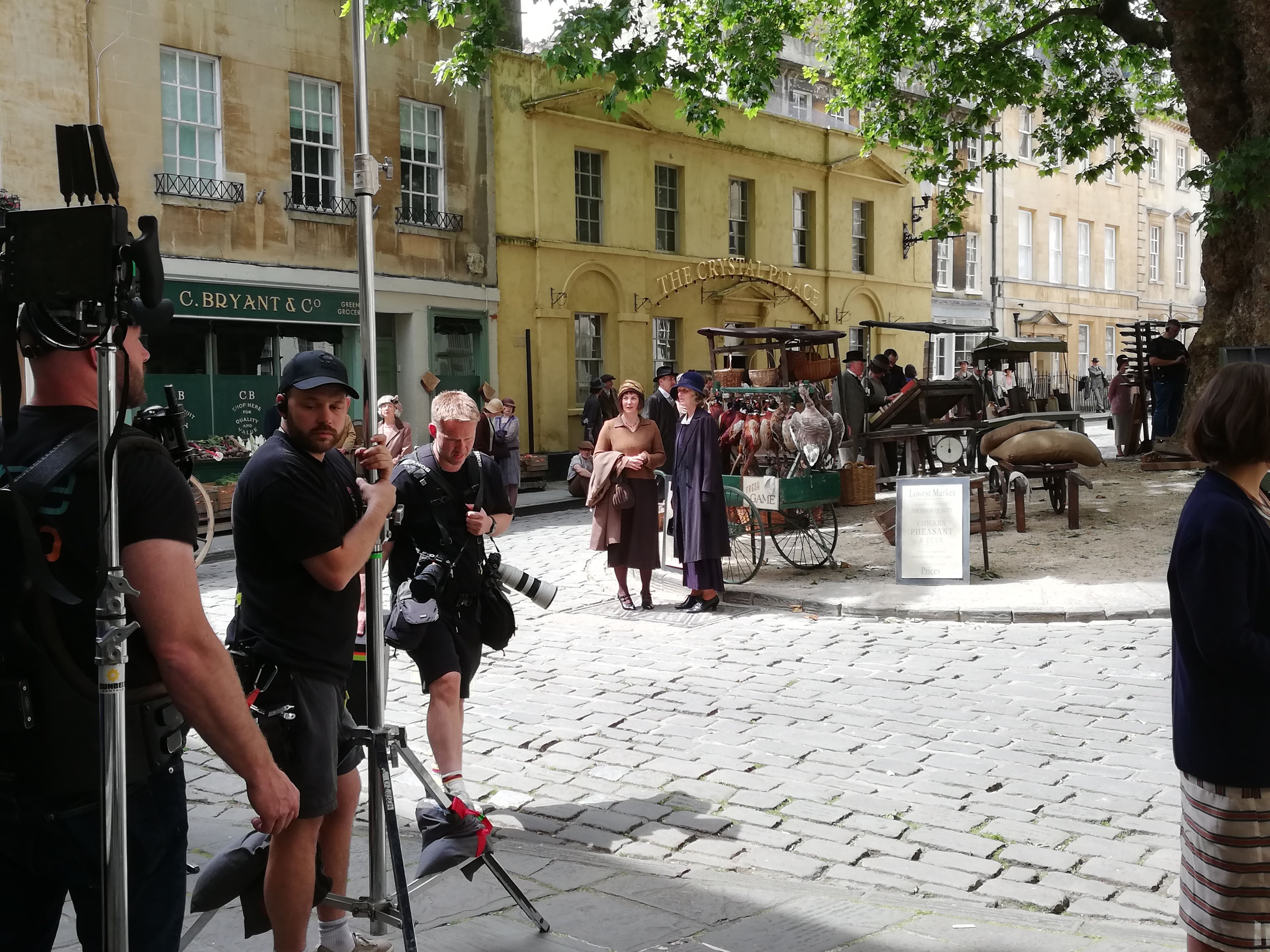 Behind the scenes photo of Netflix's Agatha Christie’s Seven Dials, featuring people in period dress.